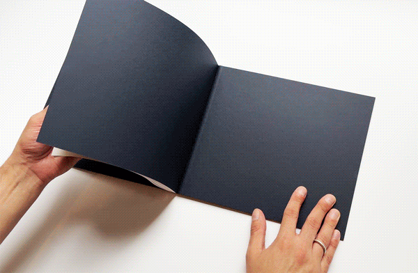 A gif showing two hands flipping through colorful pages of a book
