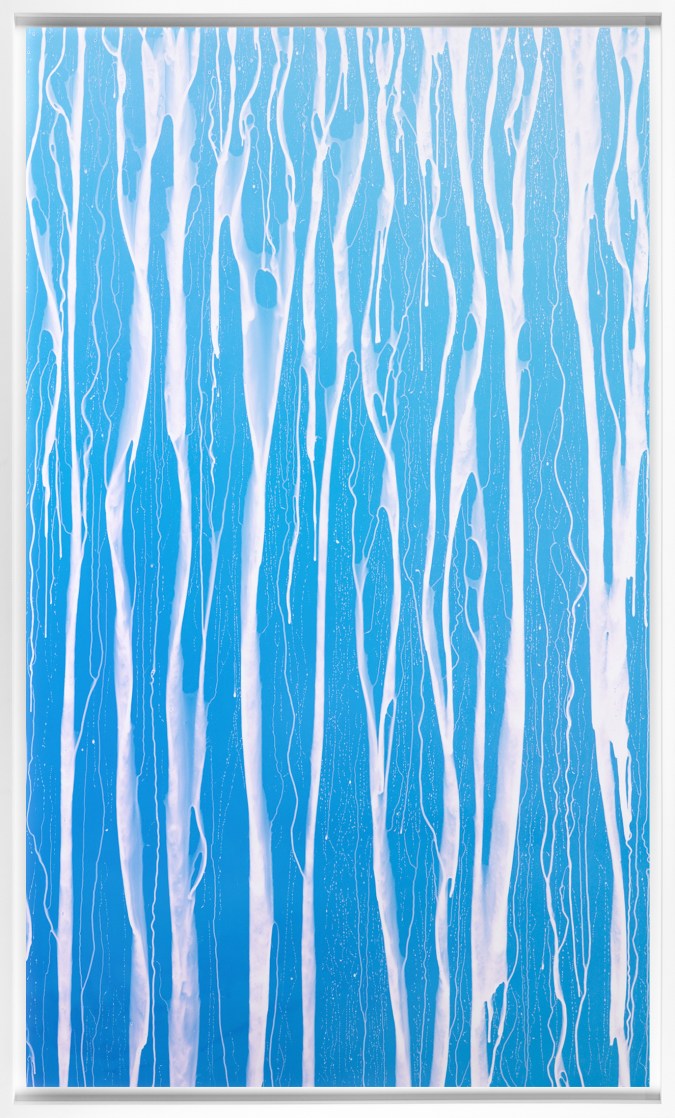 Color image of a blue and white photogram depicting water dripping framed in white