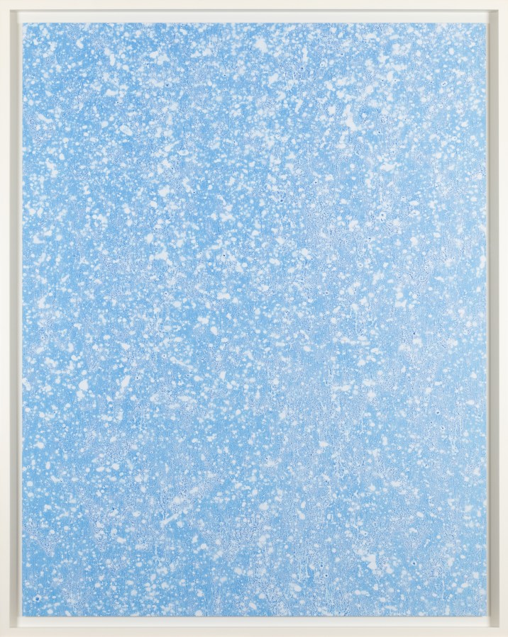 Color image of a color photograph depicting details of water in a light blue hue framed in white