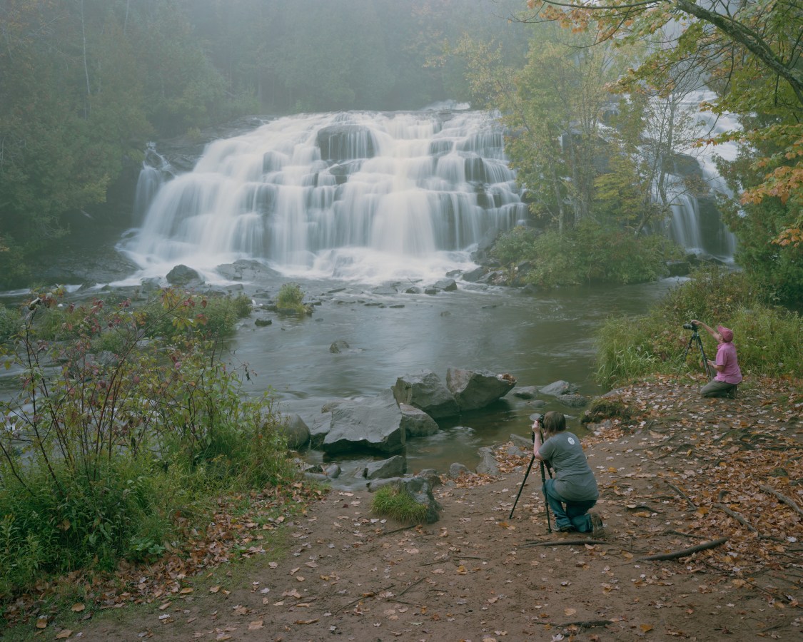 Color image of waterfall with two photographers in foreground