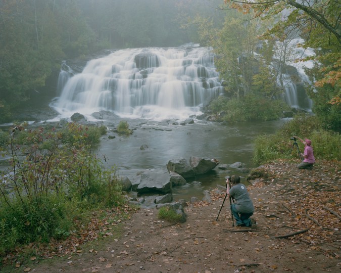 Color image of waterfall with two photographers in foreground