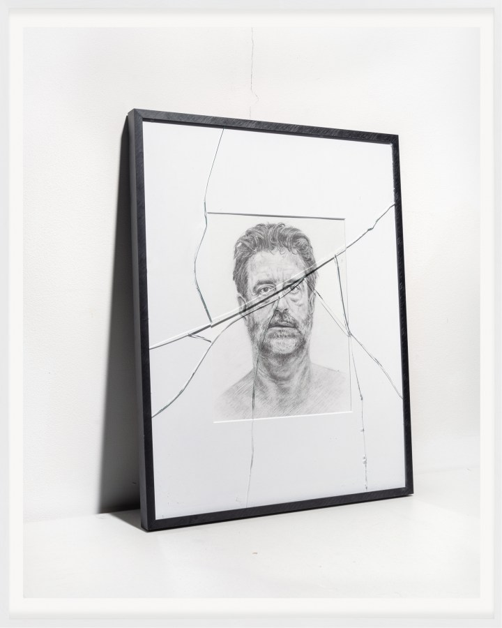 A color photograph shows a pencil drawing of Alec Soth framed behind cracked glass.