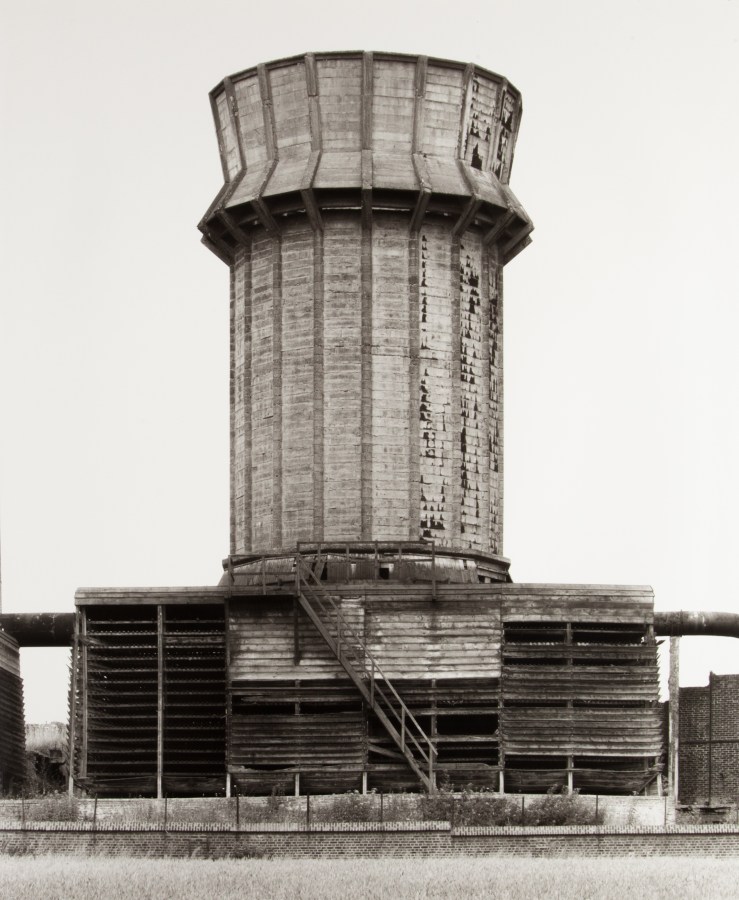 Black and white photograph of a cooling tower.