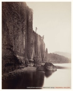 Color image of a poster with a color photograph of a cliffside and water with trees on horizon