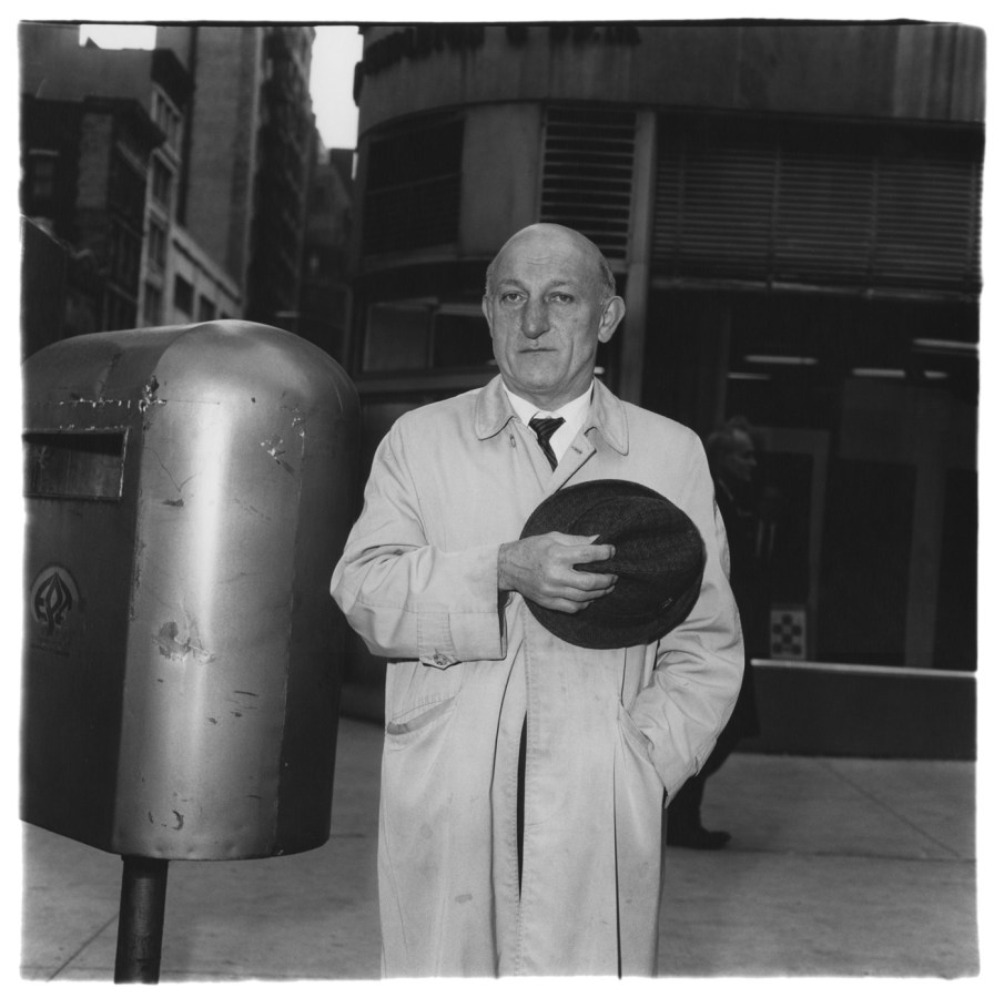 Black-and-white photograph of a man holding his hat over his heart