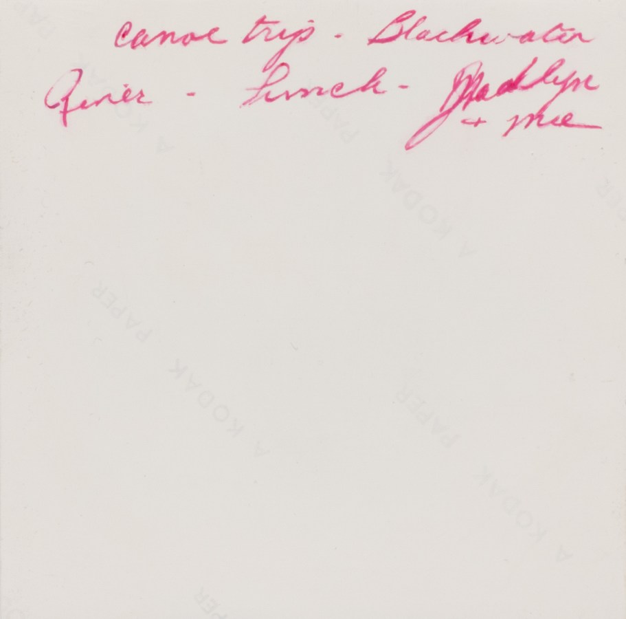 Color image of the backside of a realistically rendered painting depicting red handwriting on back of a photograph