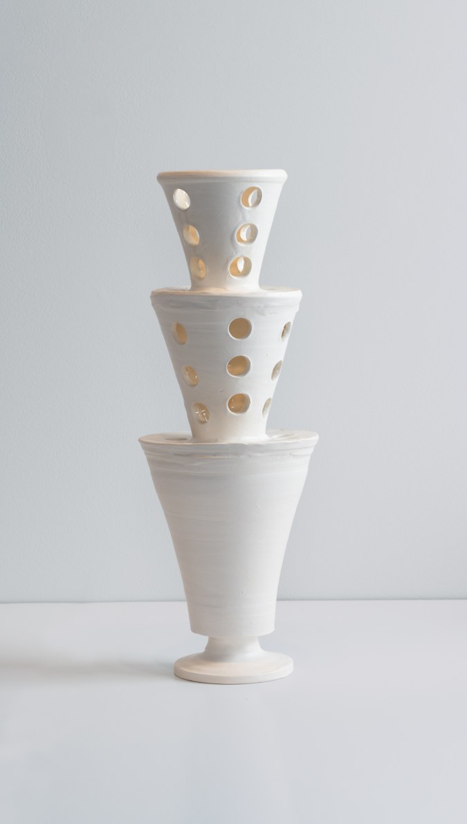 A color photograph of a white vase