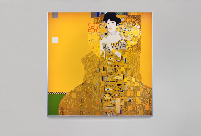 Color image of a color transparency on a light box depicting a figure in a yellow dress with adornments of various shapes against a yellow background