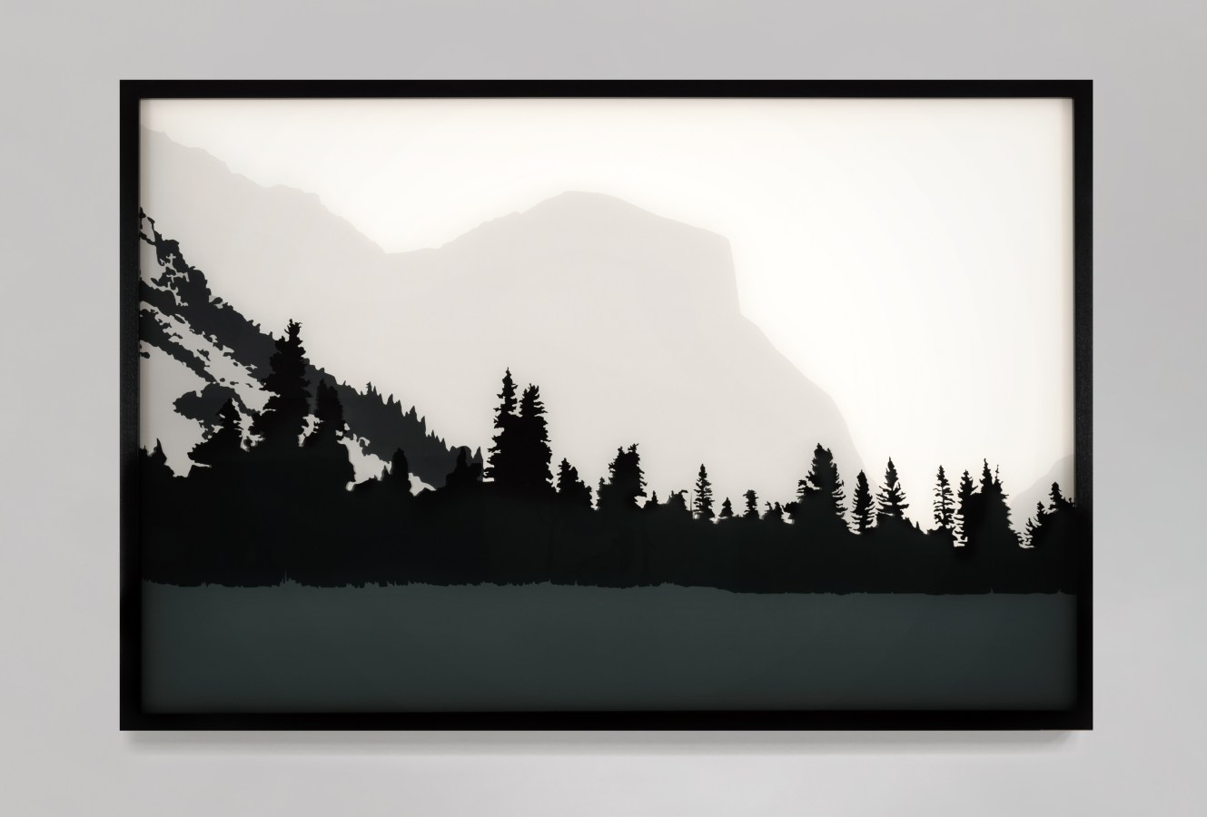Color image of a black and white transparency on a light box depicting Yosemite with mountains in the distance