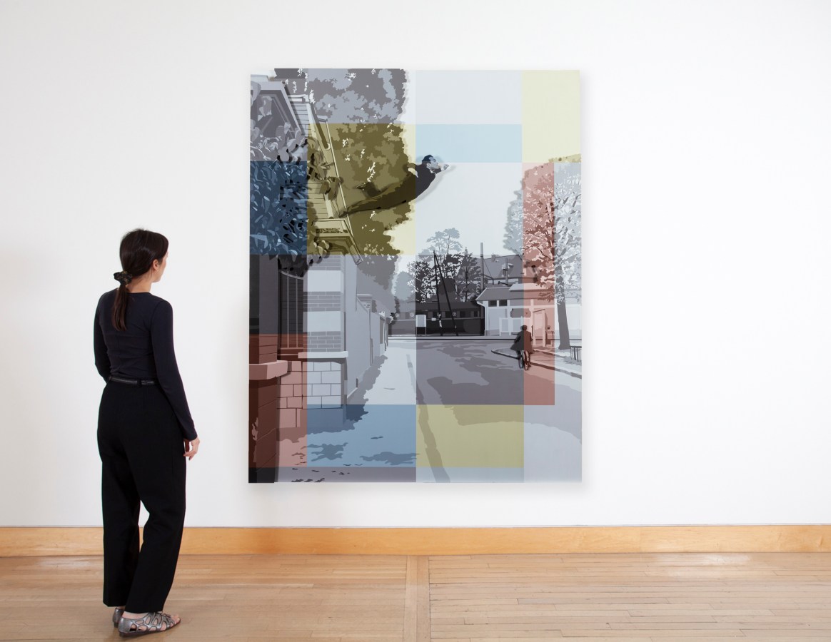 Color image of a figure viewing a mixed media artwork depicting a figure leaping onto a sidewalk on a white gallery wall