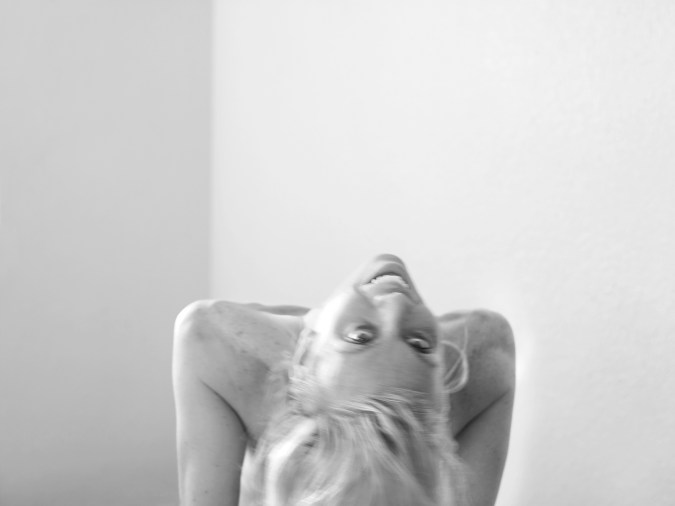 Black and white photograph of a white woman leaning backwards