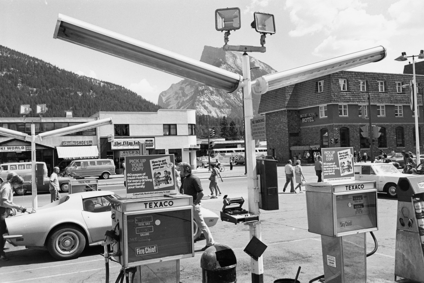 Black and white photograph of a bust town strip as take from the exterior of a gas station