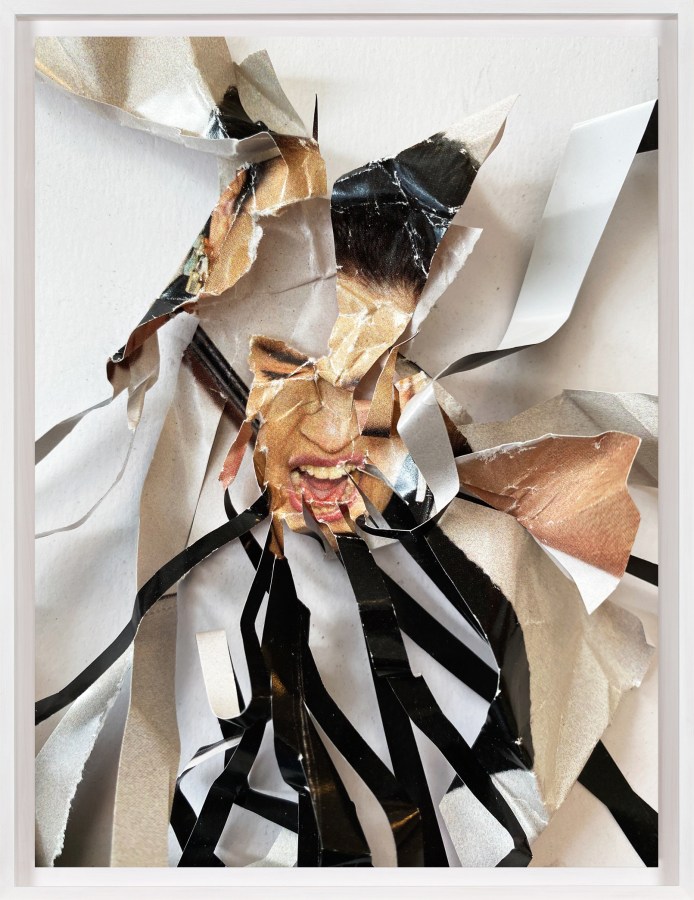 A framed collage of comic book images, with a small face at the center, and long black strips radiating out of it.