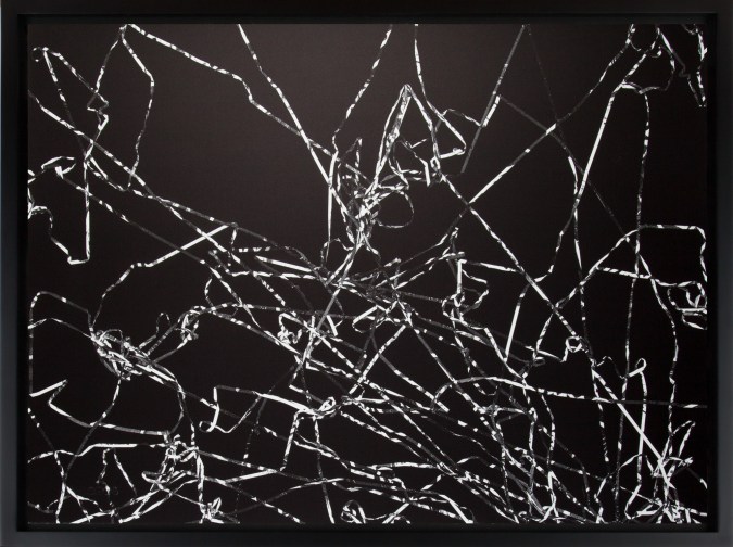 Black and white photograph of outlines of tangled cassette tape