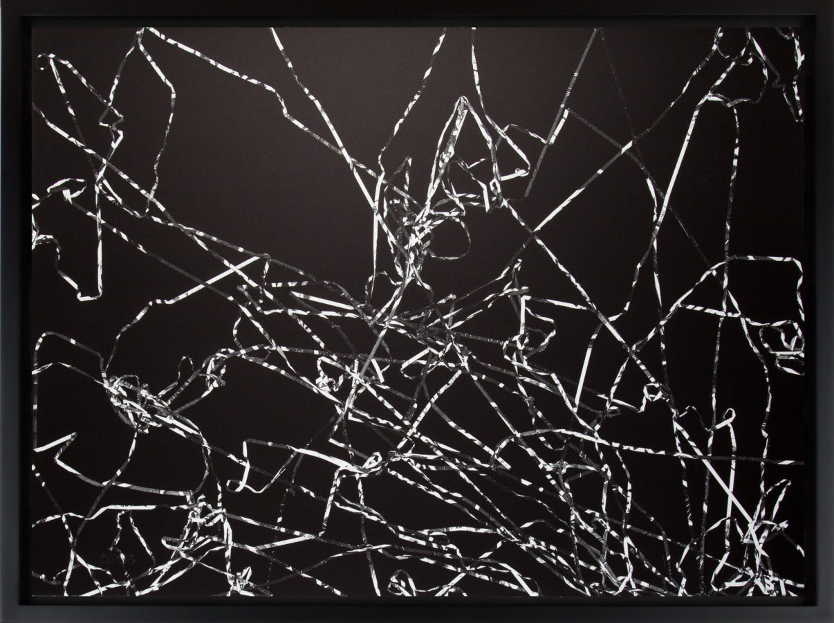 Black and white photograph of outlines of tangled cassette tape