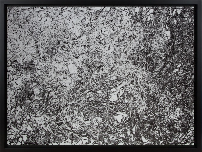 Black and white photograph of piles of tangled cassette tape