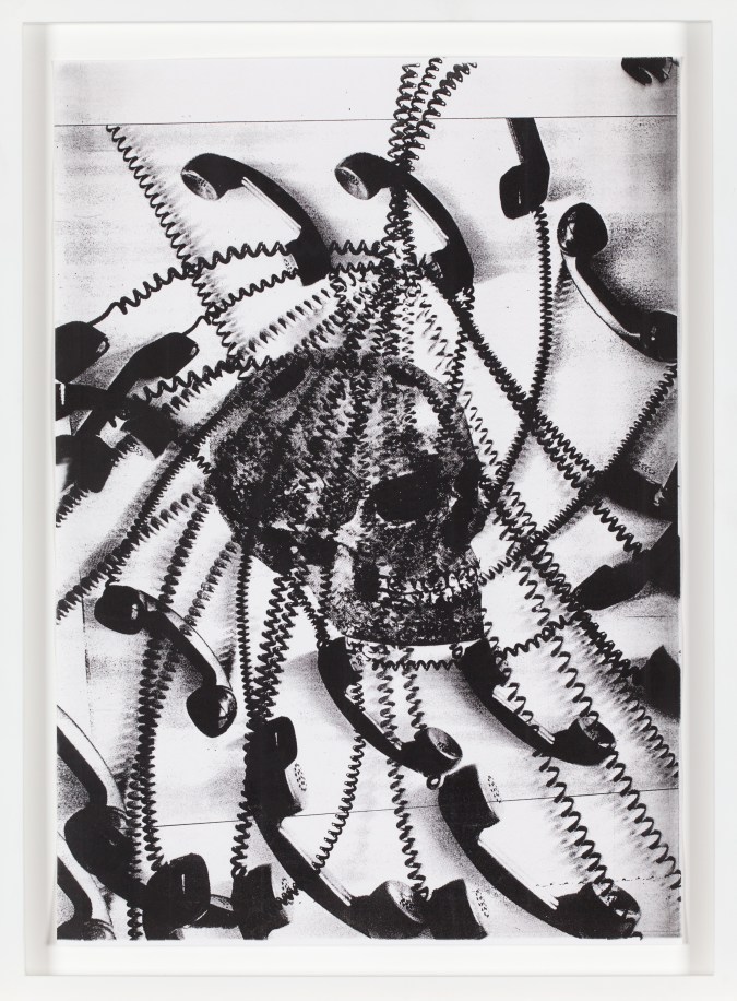 Black-and-white photocopy multiple exposure of corded telephones spiraling out from a skull.