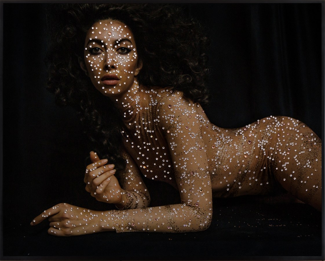 Color photograph of a reclining nude figure covered in diamonds