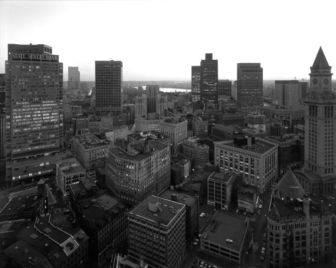 Black-and-white photograph of a city skyline with high rise buildings scattered throughout the landscape