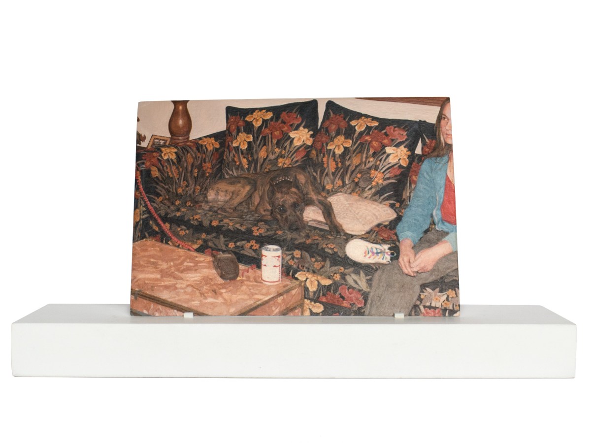 Painting of a dog and a person on a floral print couch on a wooden stand