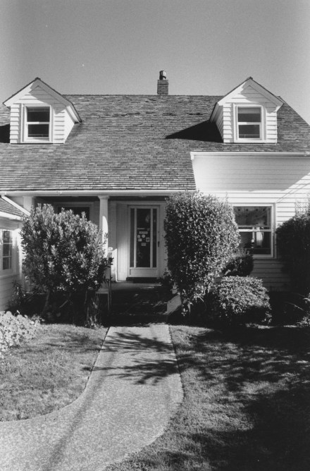 Black-and-white vertical photograph of a house.