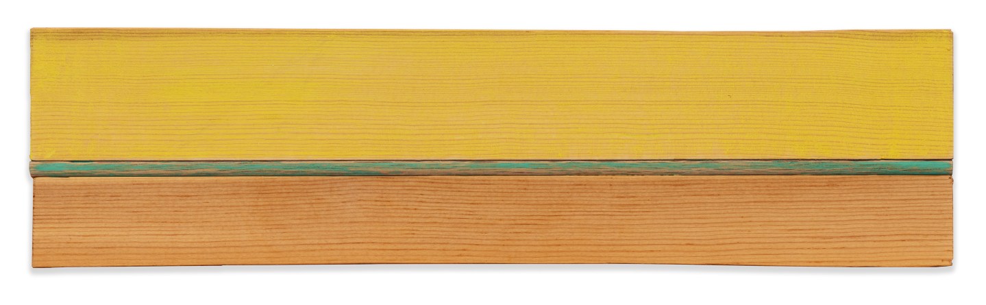 Color image of wooden sculpture with yellow and green paint