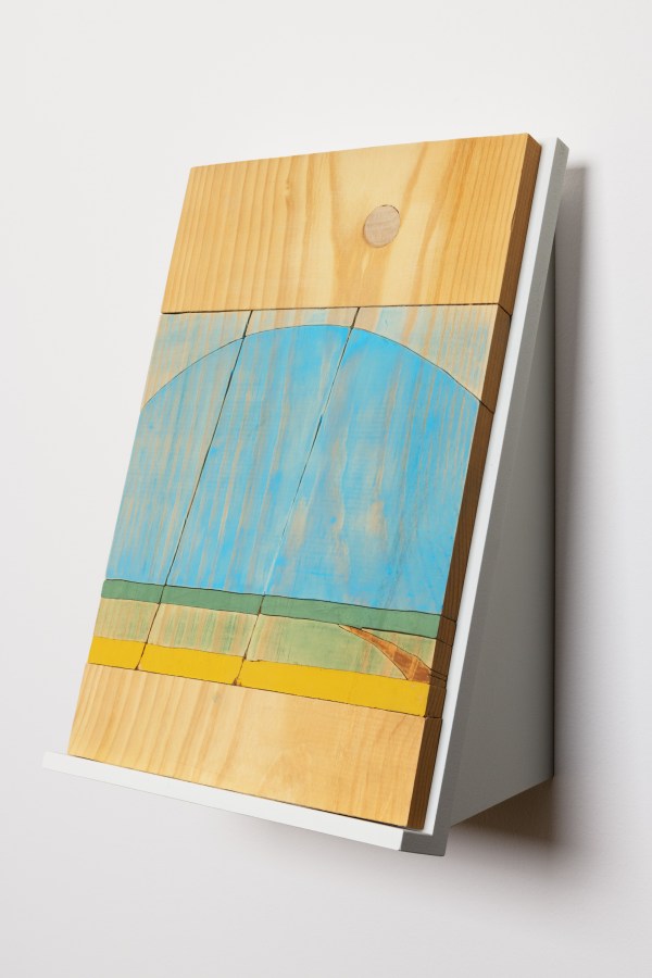 Color image of painted woodblock depicting horizon with washes of blue, green, and yellow on white stand