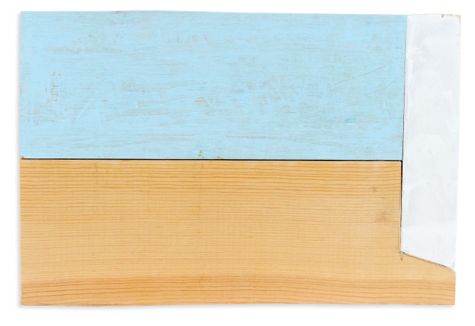 Color image of a wooden sculpture with light blue and white ink