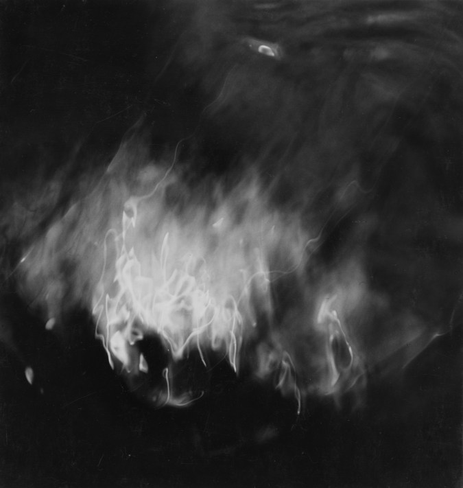 Square black-and-white photograph of light and shadow filtering through water