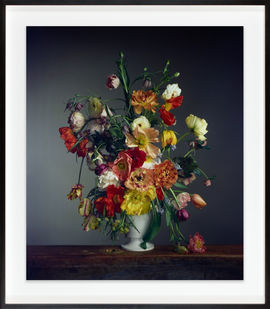A color photograph shows a bouquet of flowers in a white vase.
