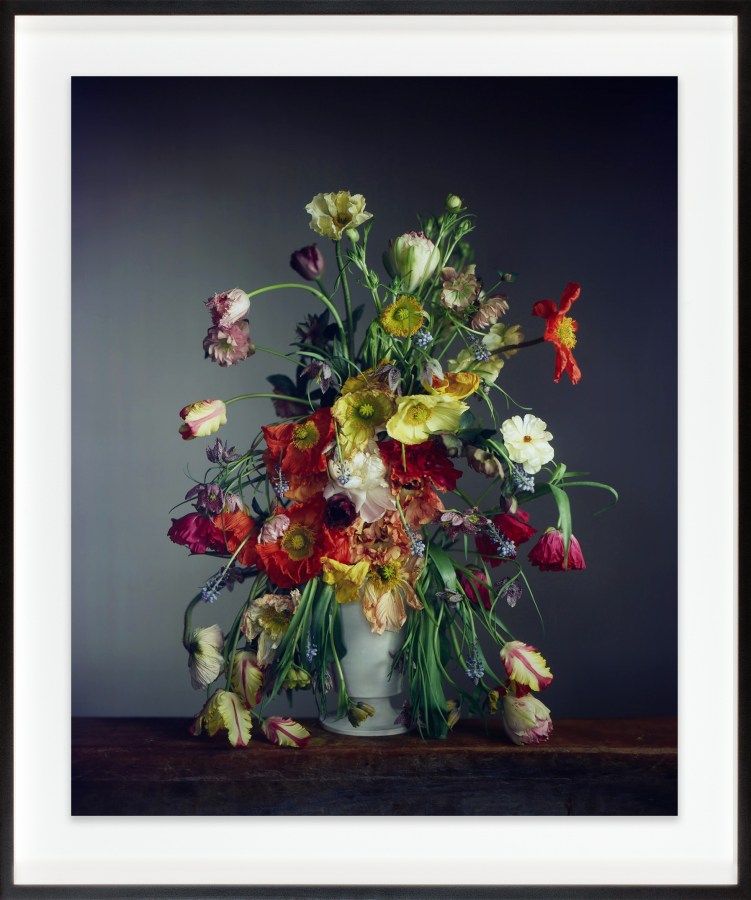 A color photograph shows a bouquet of flowers in a white vase.