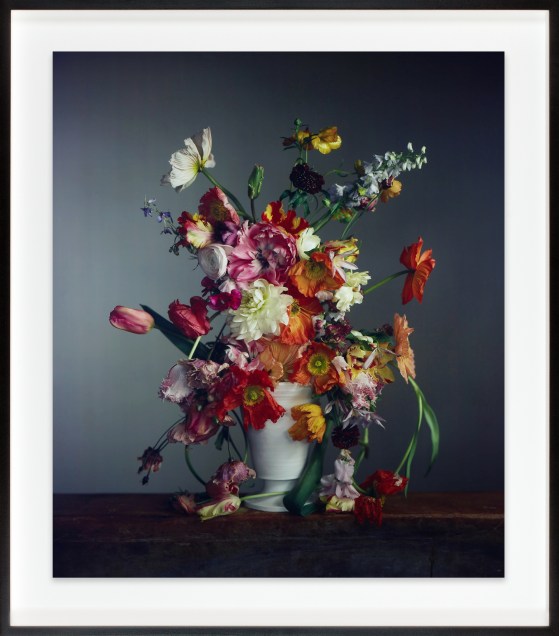 A color image shows a bouquet of flowers in a white vase.