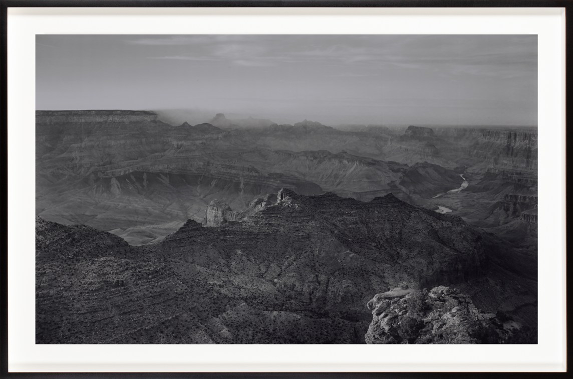 Black and white photograph of a desert canyon framed in black