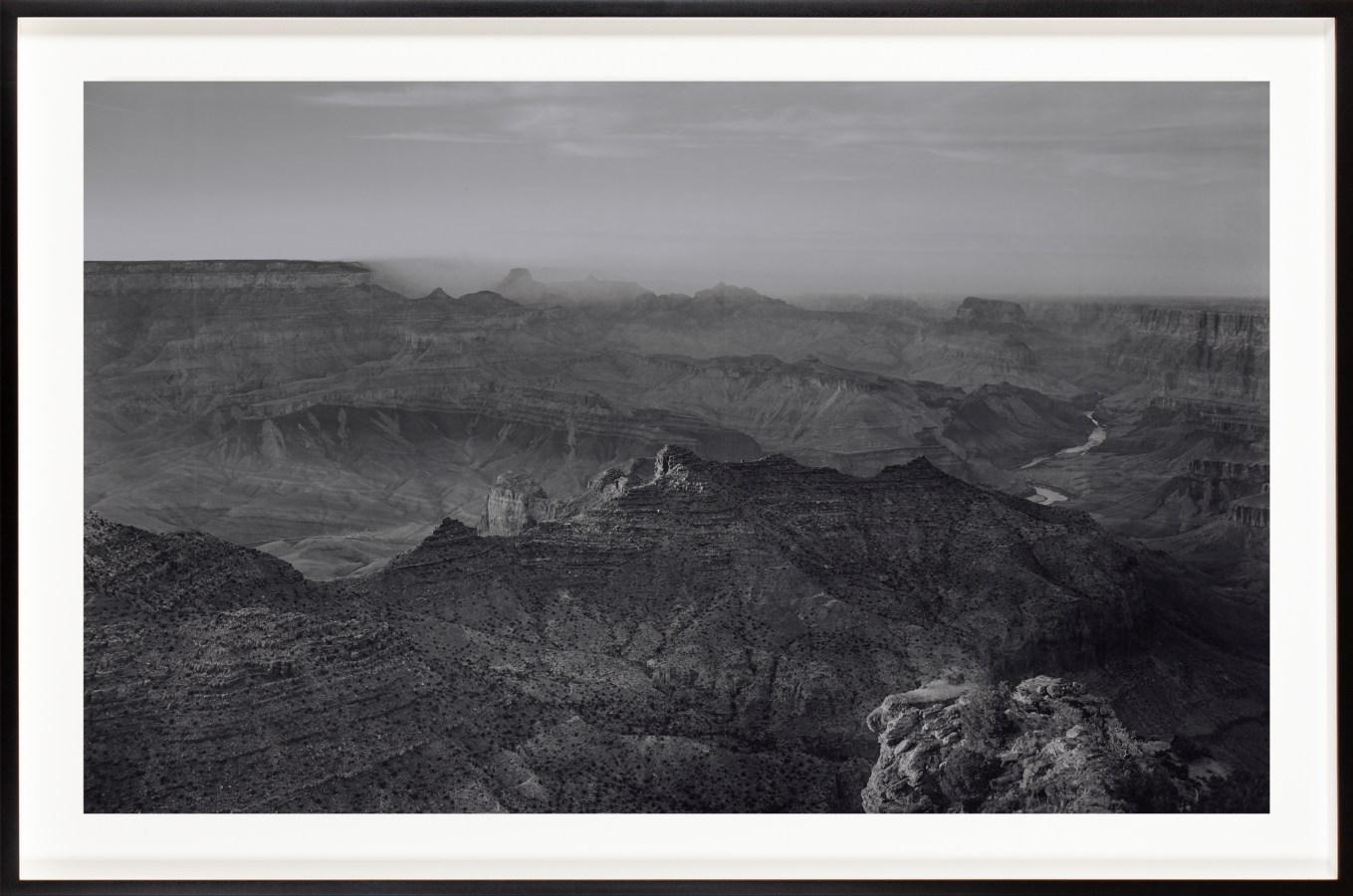 Black and white photograph of a desert canyon framed in black