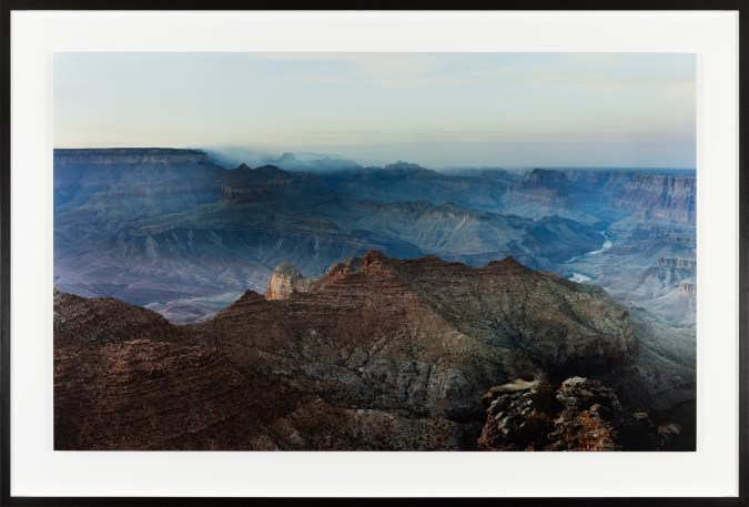 Color photograph of the Grand Canyon at sunset framed in black