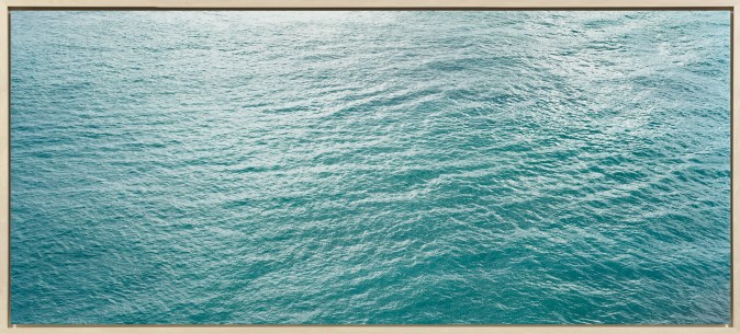 Color photograph of the surface of a calm blue ocean