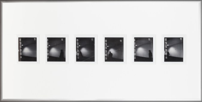 Color image of six black and white polaroids with time stamps depicting shadowy figures in silver frame