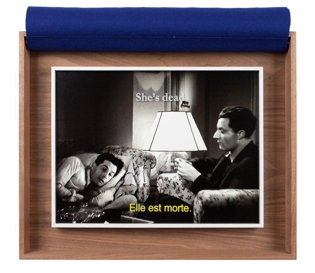 A wooden box with a photograph from a black and white movie inside