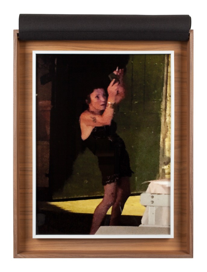 A wooden box with a photograph inside of a woman