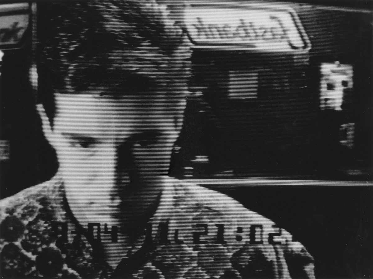 Black and white photograph of a man at an ATM