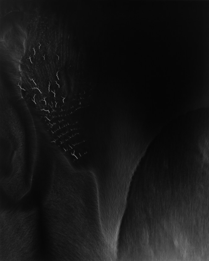 Black and white photograph of lighting striking against black background