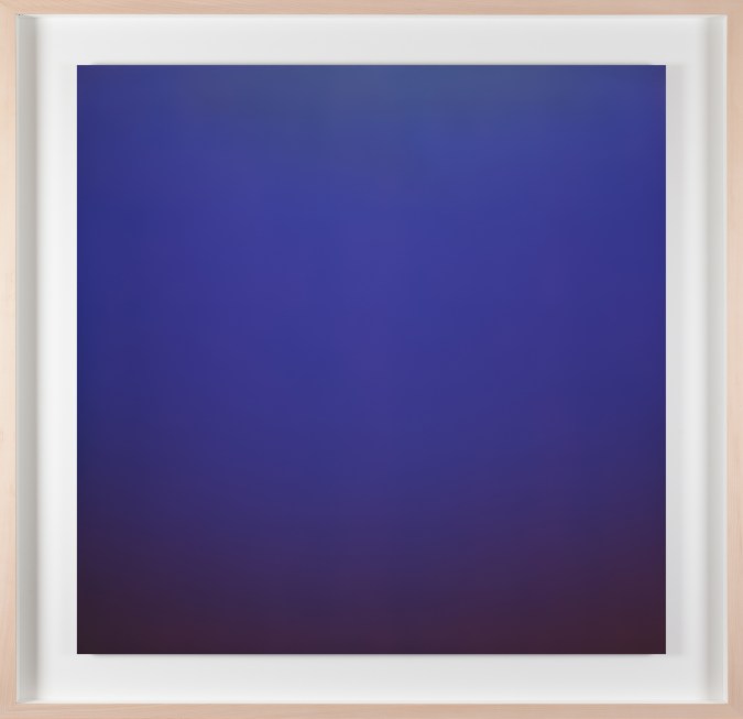 Vertical photograph of a blue color field, with a black bottom edge