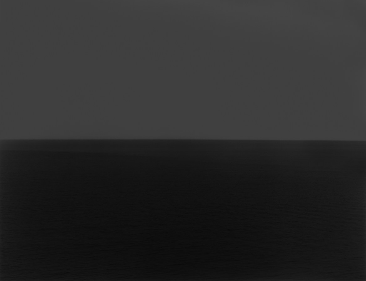 Black and white photograph of the horizon with equal parts sky and sea