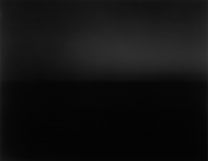 Black and white photograph of the horizon with equal parts sky and sea