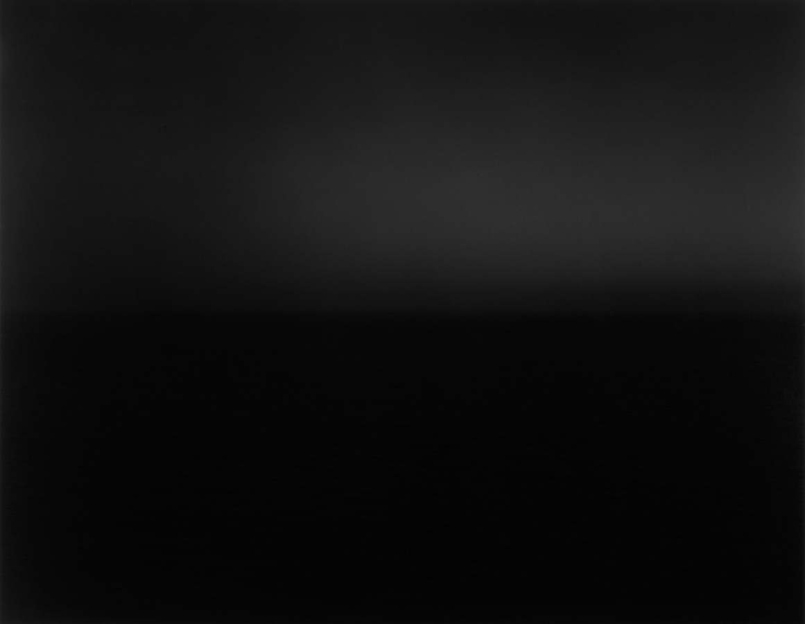 Black and white photograph of the horizon with equal parts sky and sea