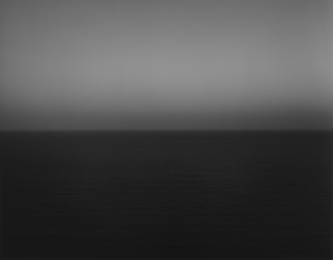 Black and white photograph of the horizon with equal parts sky and sea