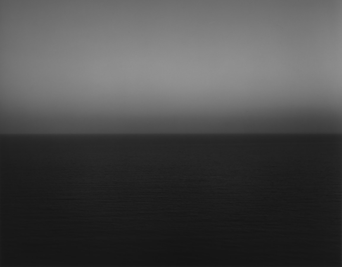 Black and white photograph of the horizon with equal parts sky and sea