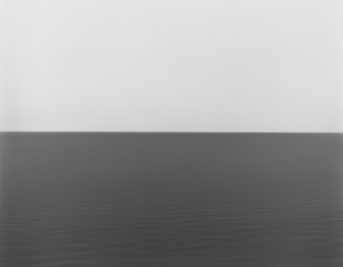 Black and white photograph of the horizon with equal parts sky and sea