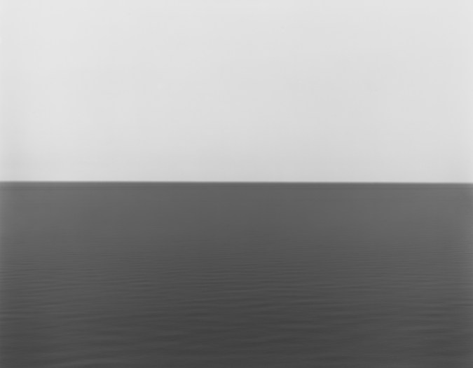 Black and white photograph of the horizon with equal parts sky and sea