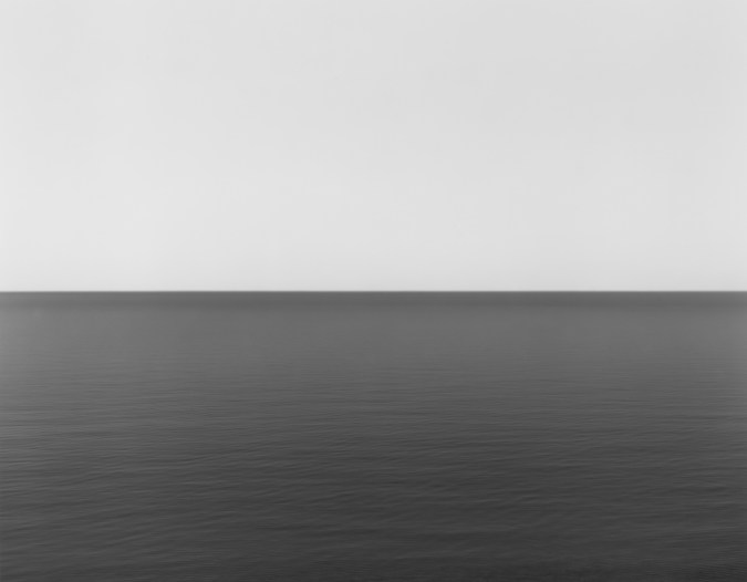 Black and white photograph of the horizon with equal parts sky and sea